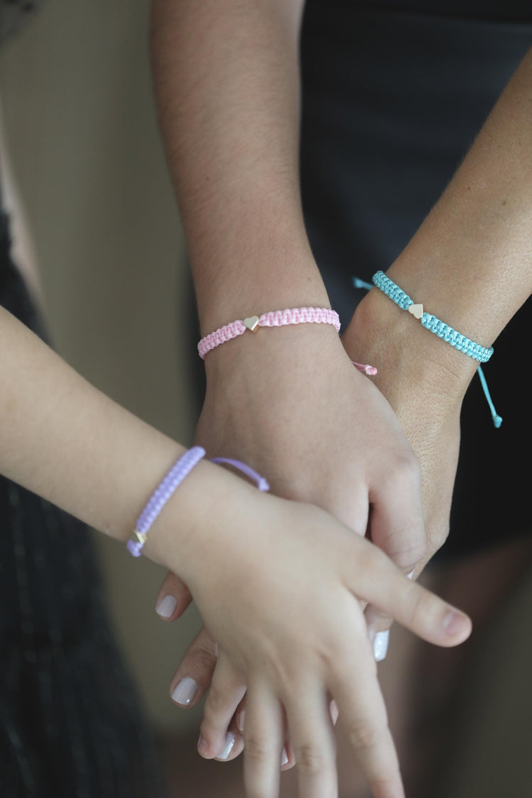 Purple, Pink, and Seagreen Bracelets with Gold Heart Charms.
