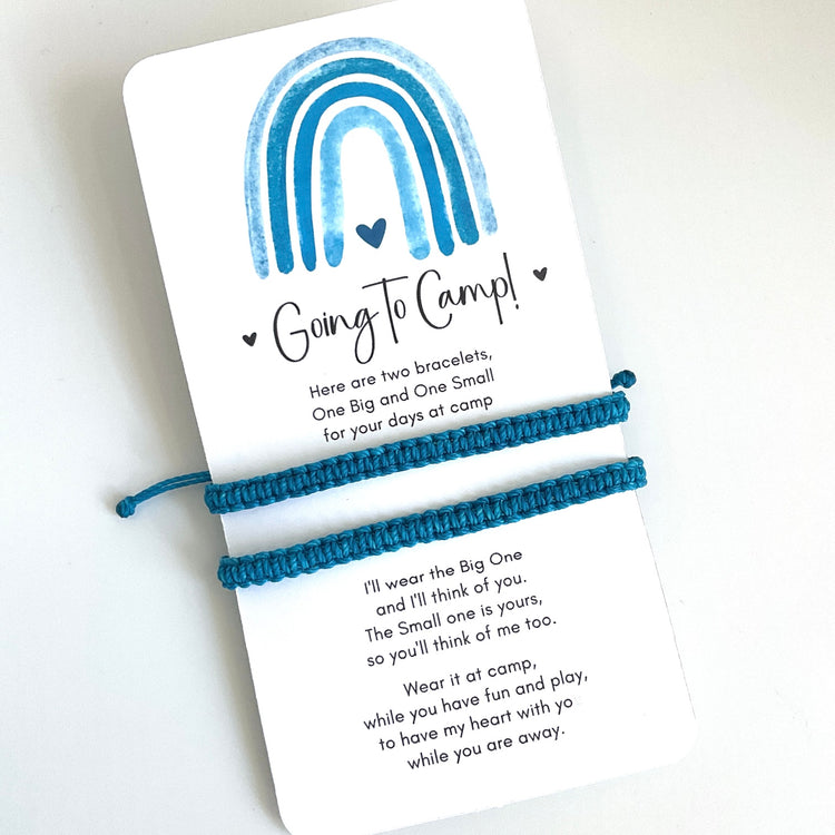Two turquoise bracelets on a card with text and a rainbow design, on a white background