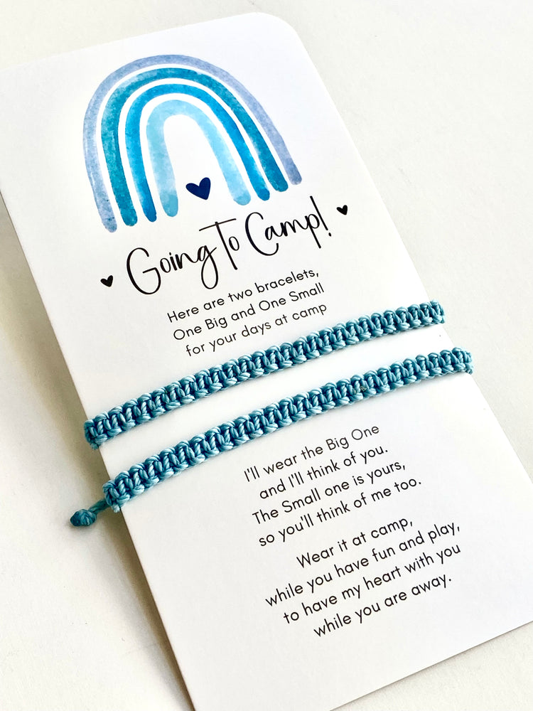 Two mint  bracelets on a card with text and a rainbow design, set against a white background.