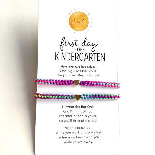 Two colorful braided matching bracelets with gold heart charms on a &quot;First Day of Kindergarten&quot; card featuring a smiling sun illustration and a sweet message for parent and child to stay connected on the first day of school.