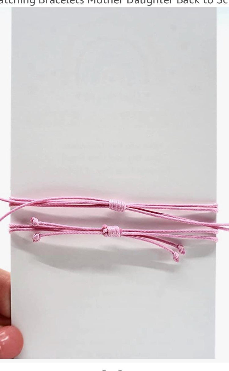 Mommy and Me bracelets with silver heart charms and silver beads. The bracelets are made of 1mm waterproof cord in pink, purple, teal, and coral colors. Minimalist design.