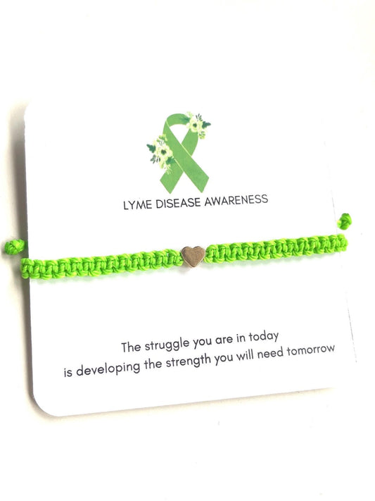 Neon green adjustable bracelet with a heart charm on a Lyme Disease Awareness card that reads, &quot;The struggle you are in today is developing the strength you will need tomorrow.