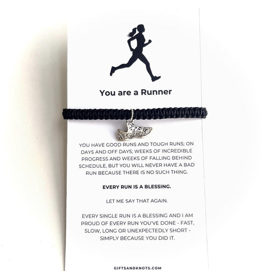 Handmade black adjustable bracelet with a silver running shoe charm on a motivational card that reads &#39;You are a Runner&#39; with a silhouette of a runner.